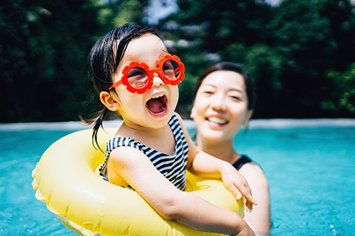 Mother an daughter swimming in a pool