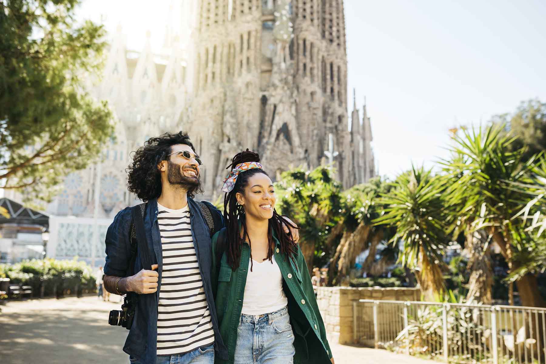 Smiling couple walking around Sagrada Familia church at Barcelona, Catalonia, Spain