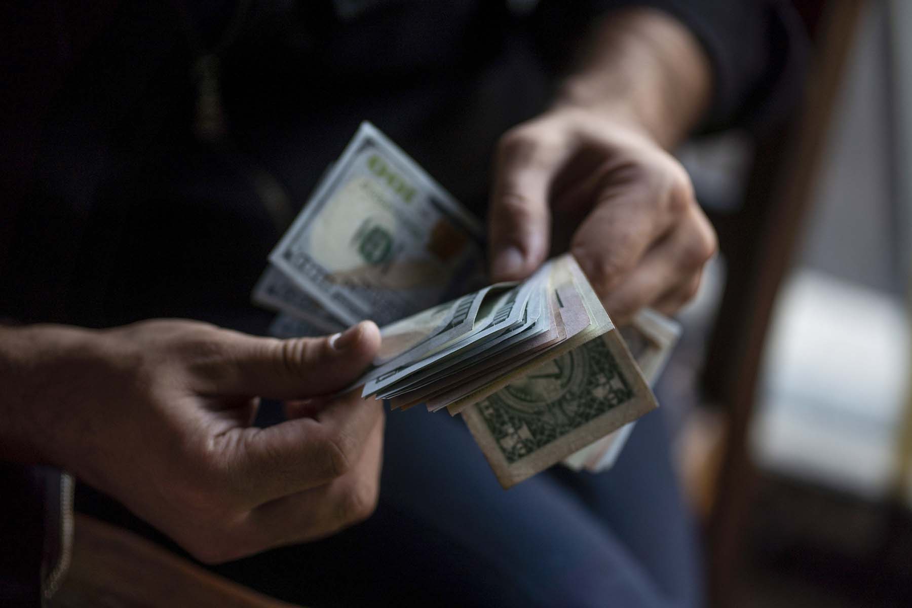Closeup of person's hands counting cash