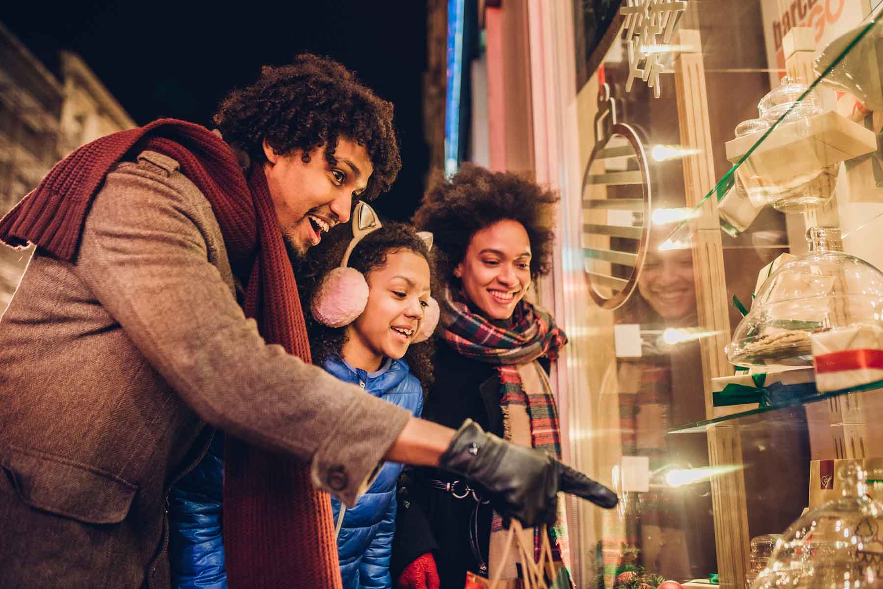 Smiling young family looking at candy and Christmas presents