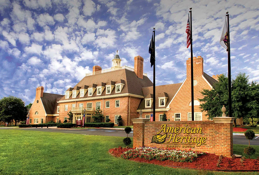 American Heritage Campus In front of a sign with their Logo