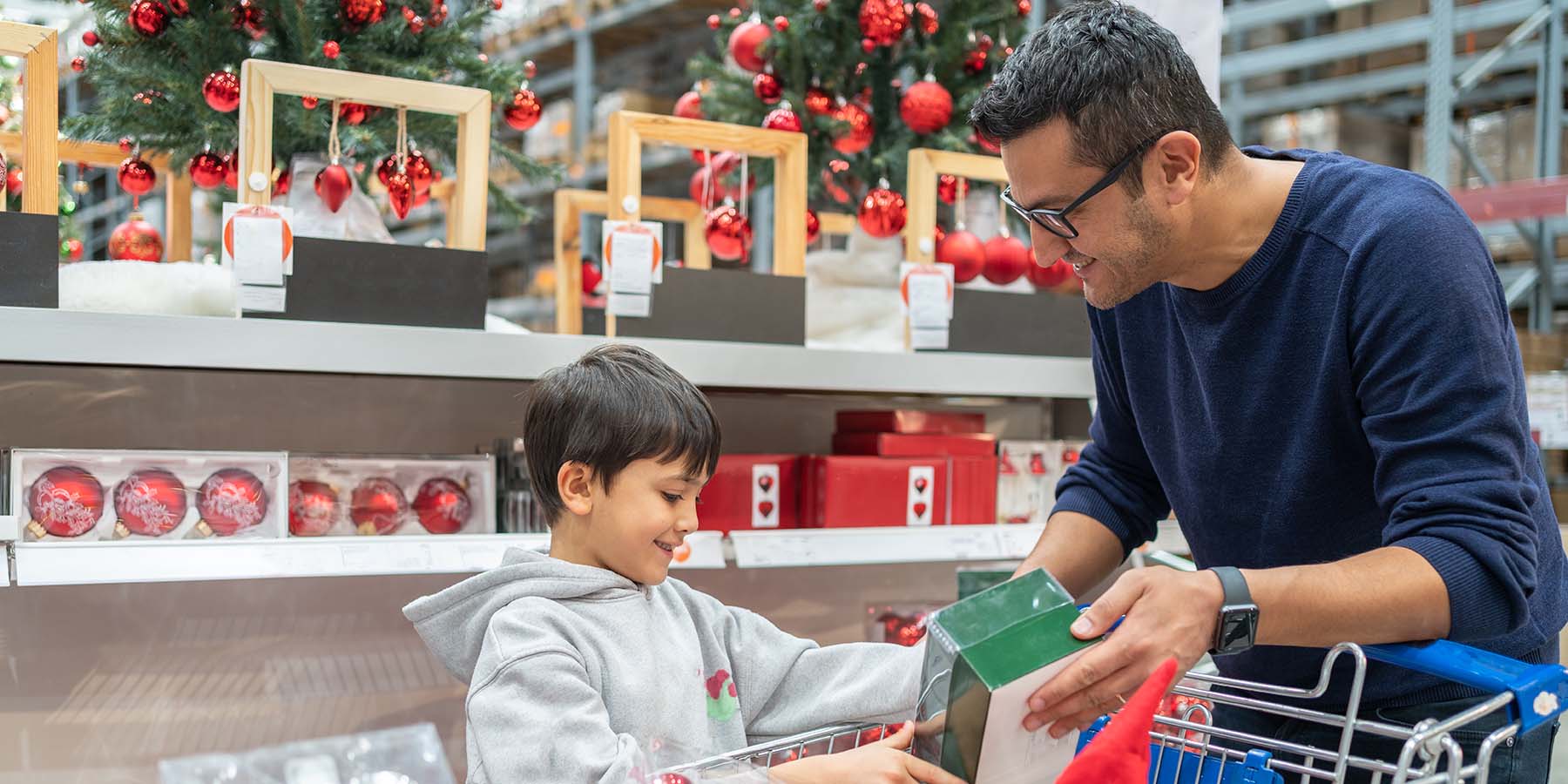 A father shopping during the winter holidays with his young son