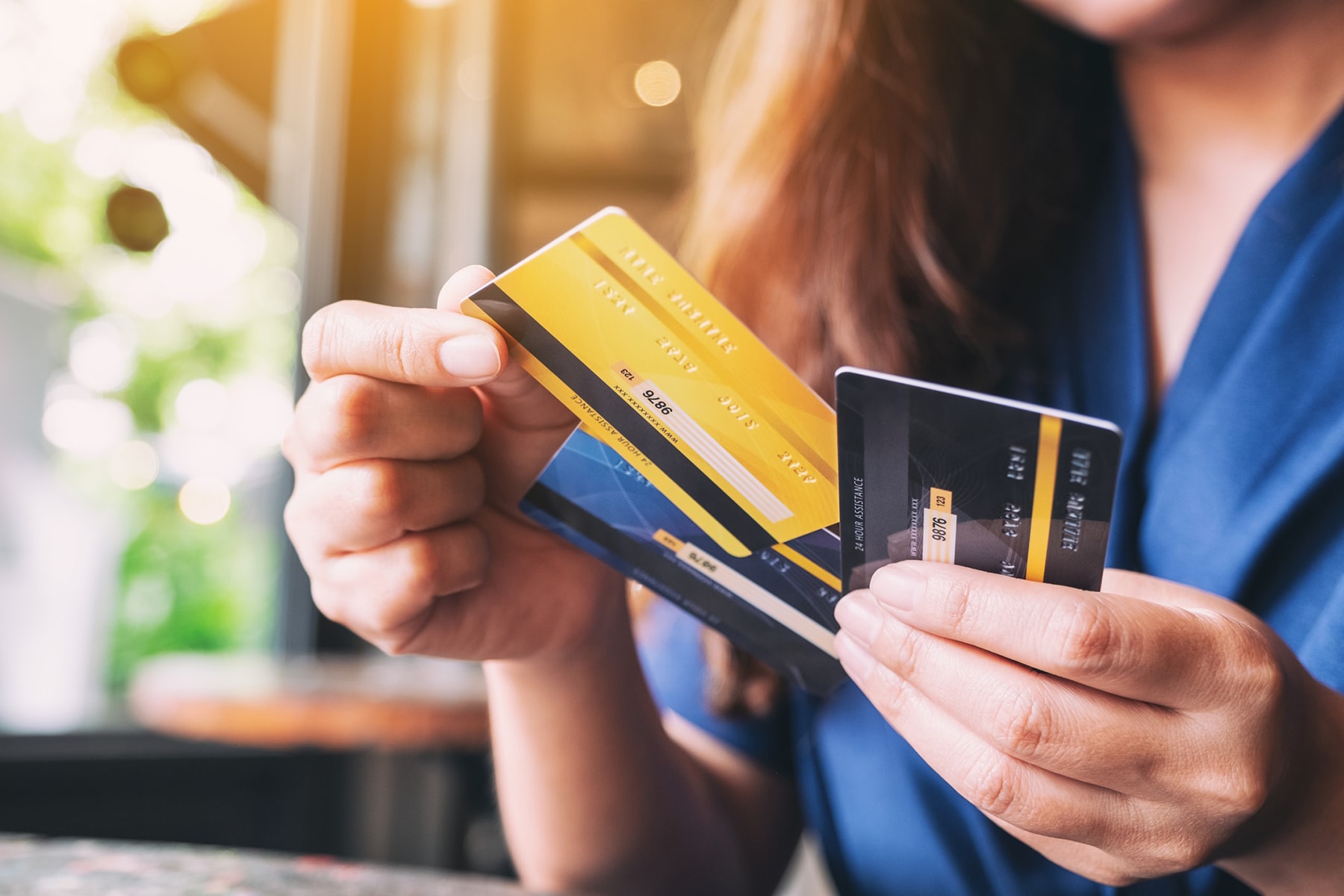 A woman holding a variety of payment cards