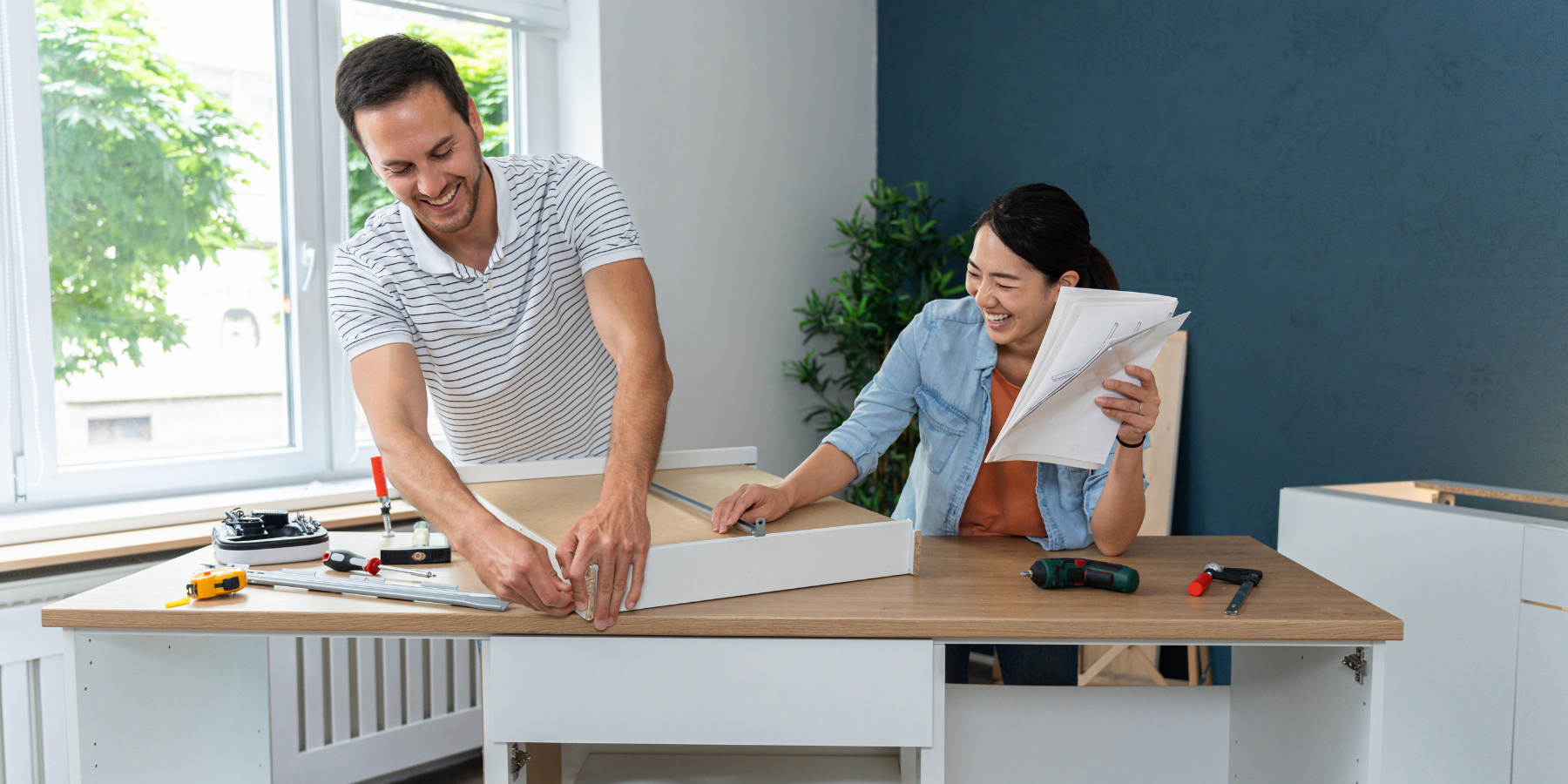 Couple asembling a cabinet