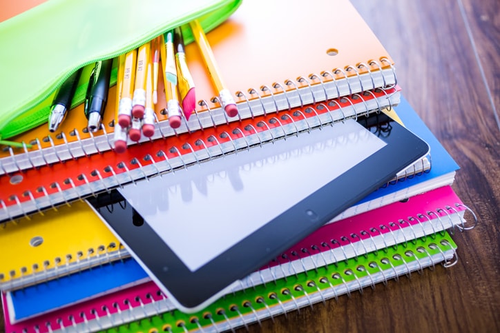 stack of notebooks on desk