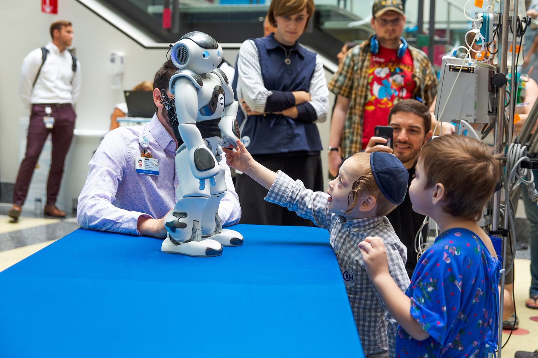 kids looking at robot on table