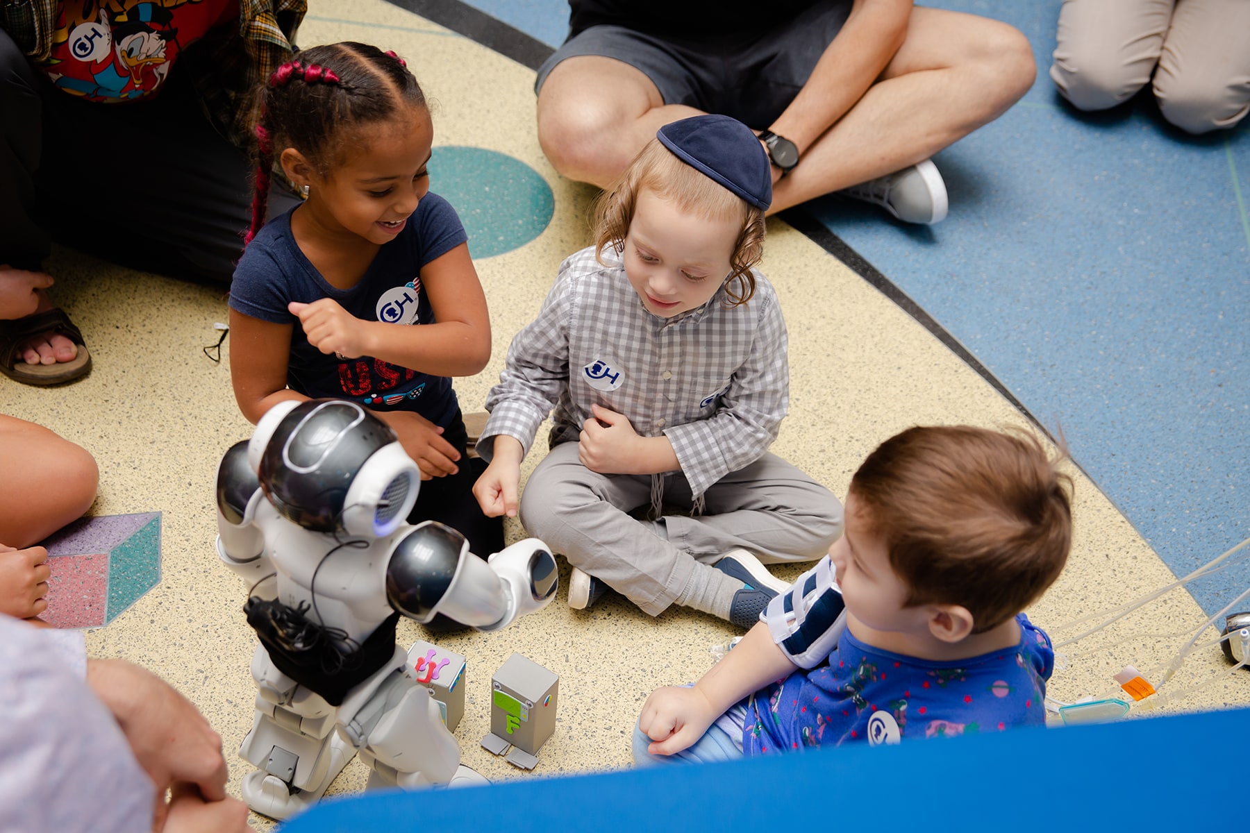 boy sitting on ground with robot