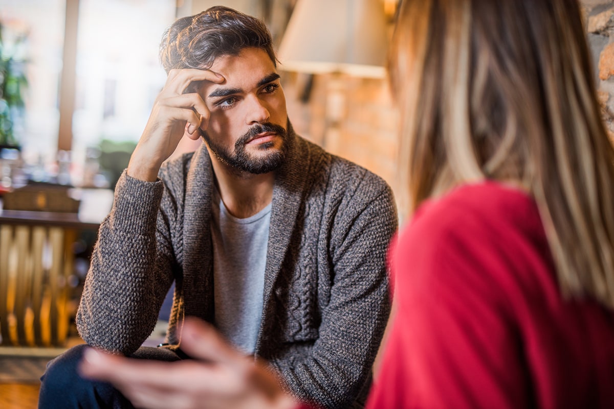 Young man talking to young woman about problems