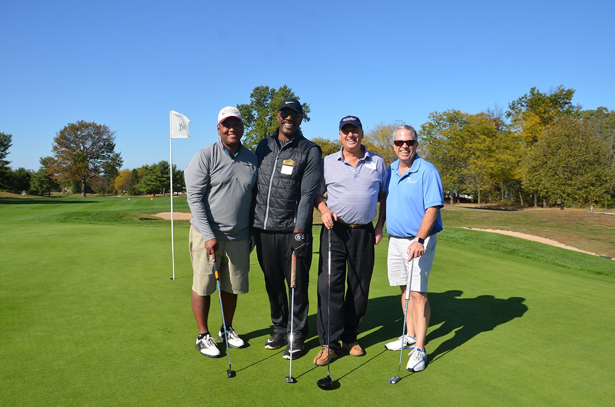 American Heritage's President & CEO, Bruce Foulke standing with attendees of Kids-N-Hope Foundation’s 24th Annual Golf Classic