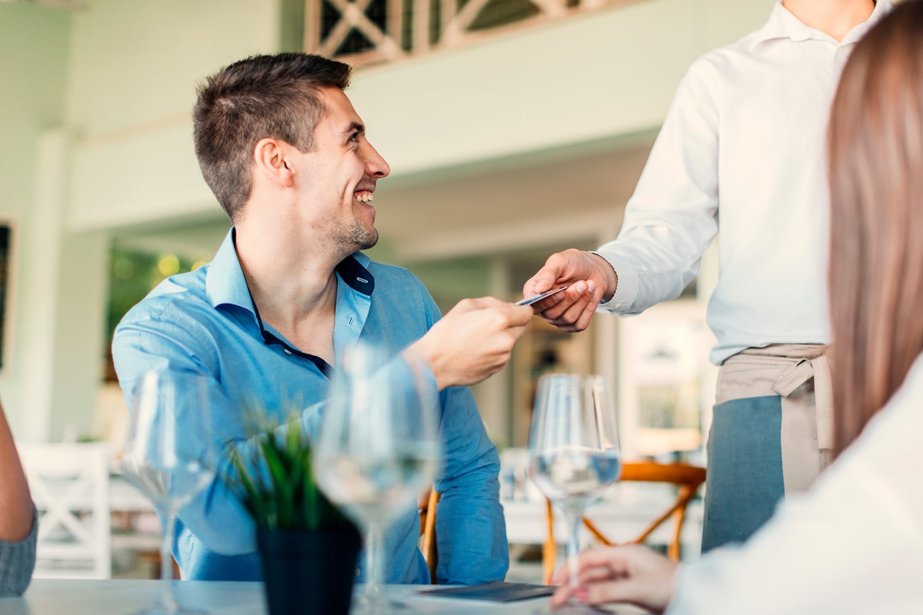 Young man paying with a credit card