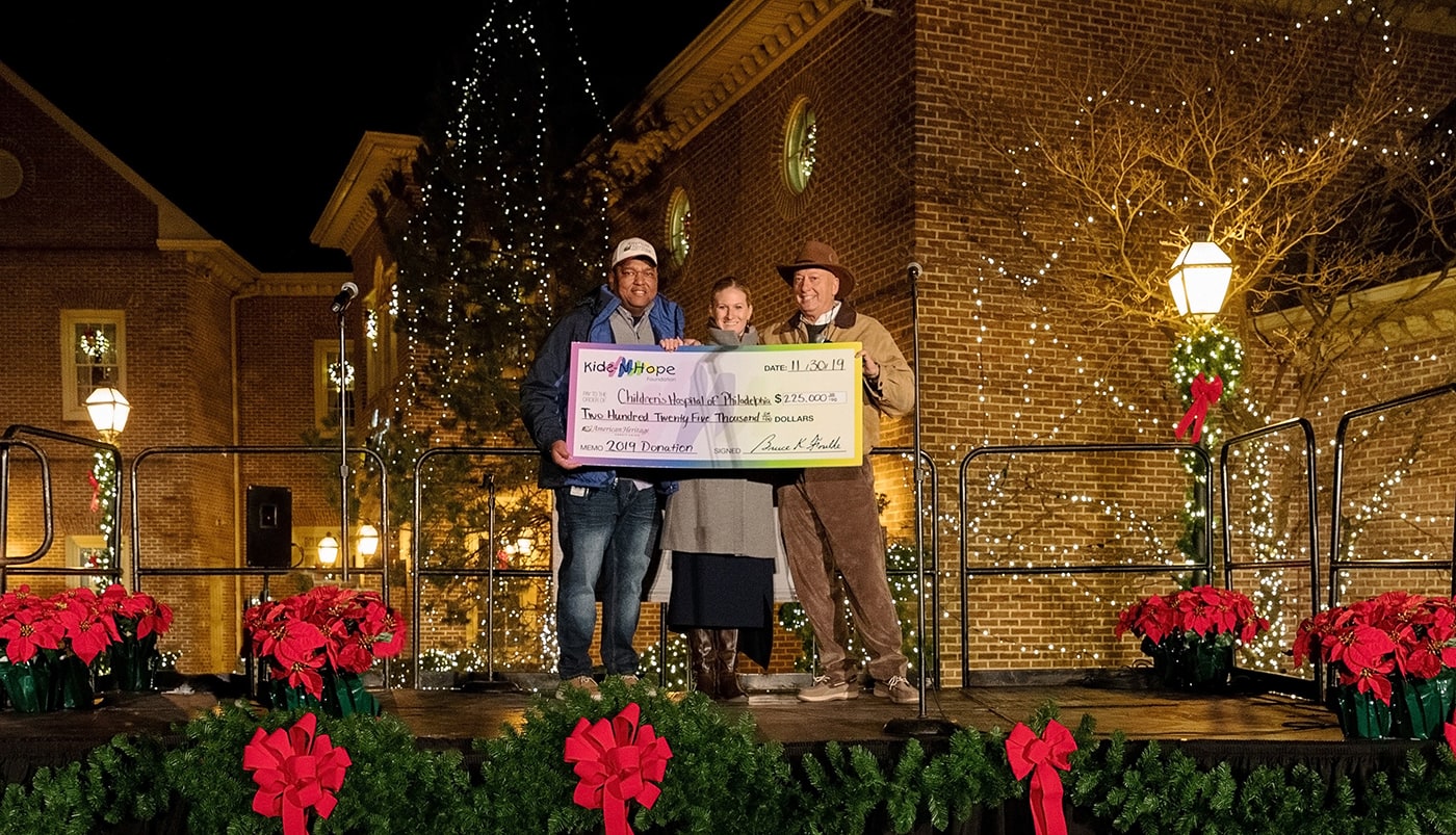 Check Presentation on Stage behind holiday lights
