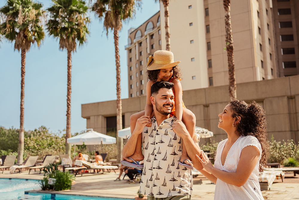 a young couple with their child on their shoulders