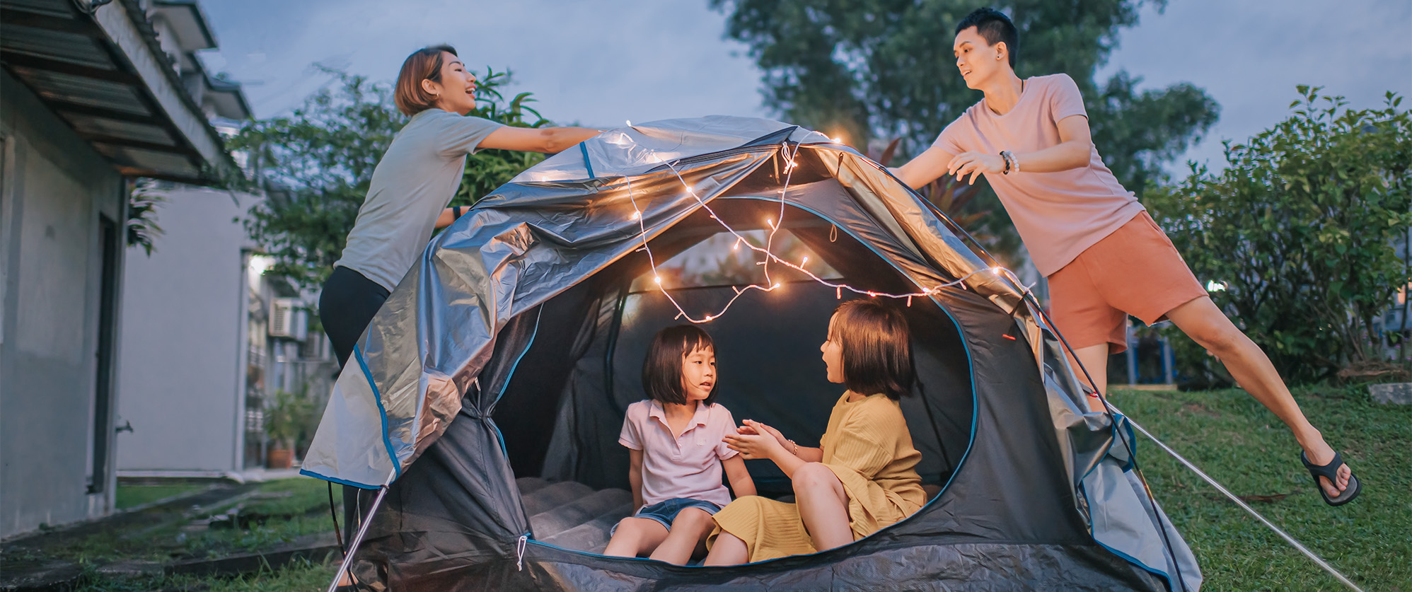 Family setting up a tent