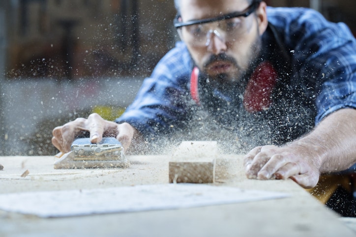 Man blowing sawdust