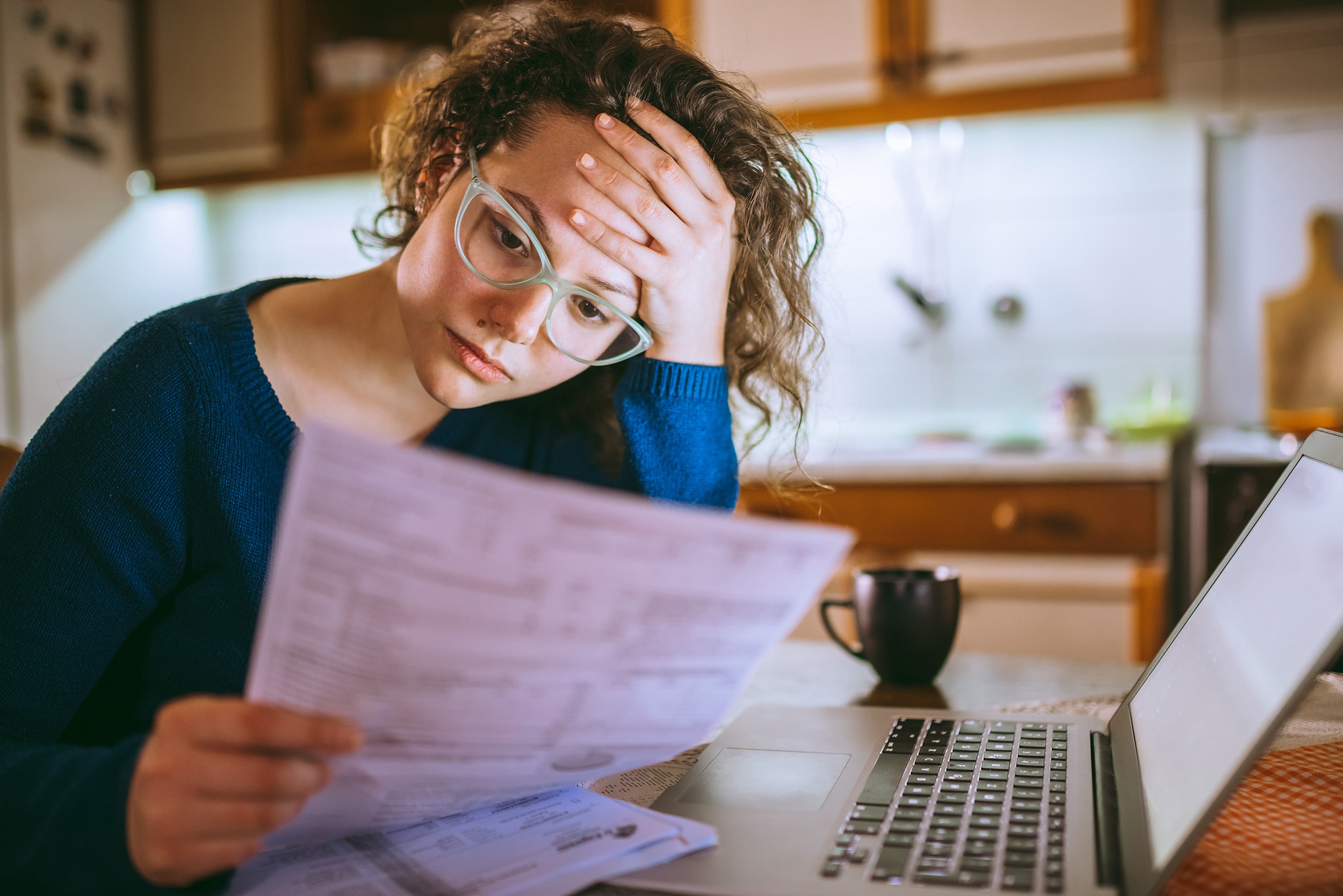Frustrated young woman looking over her finances
