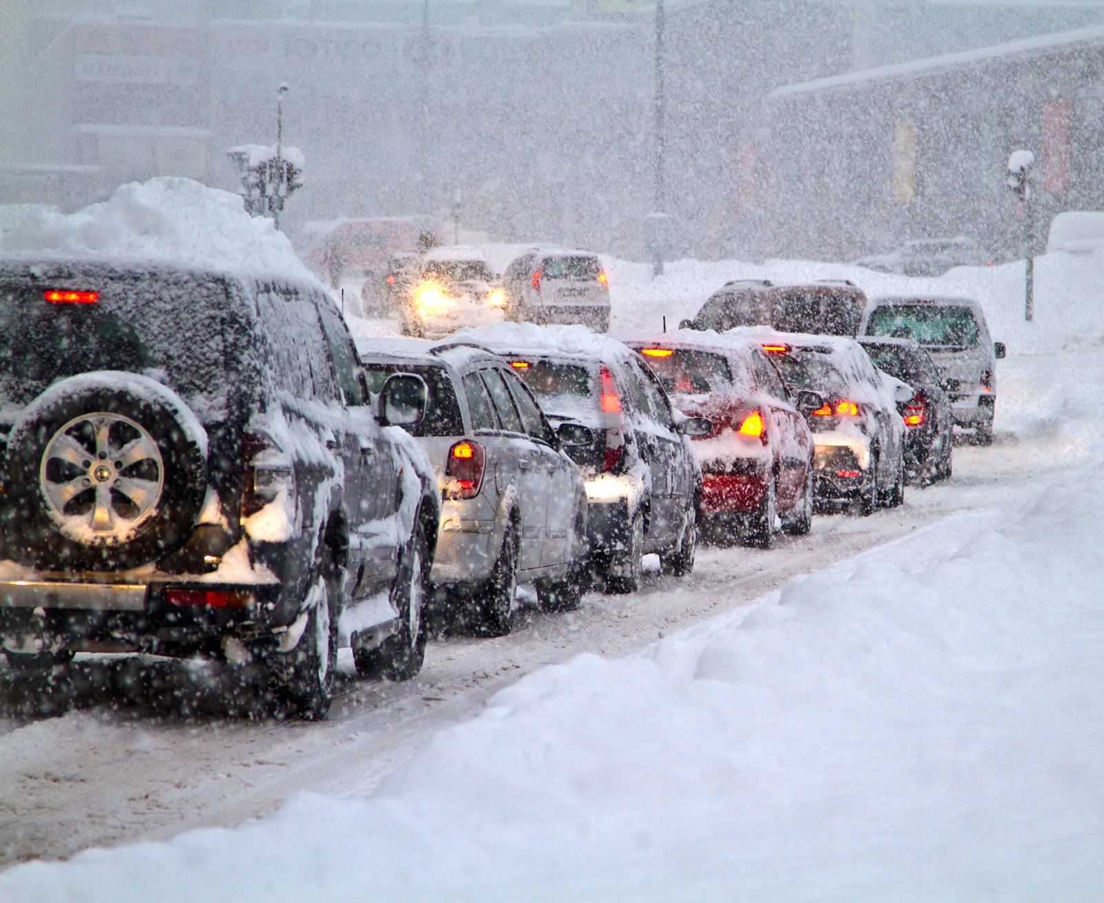 Line of cars on road in snow storm