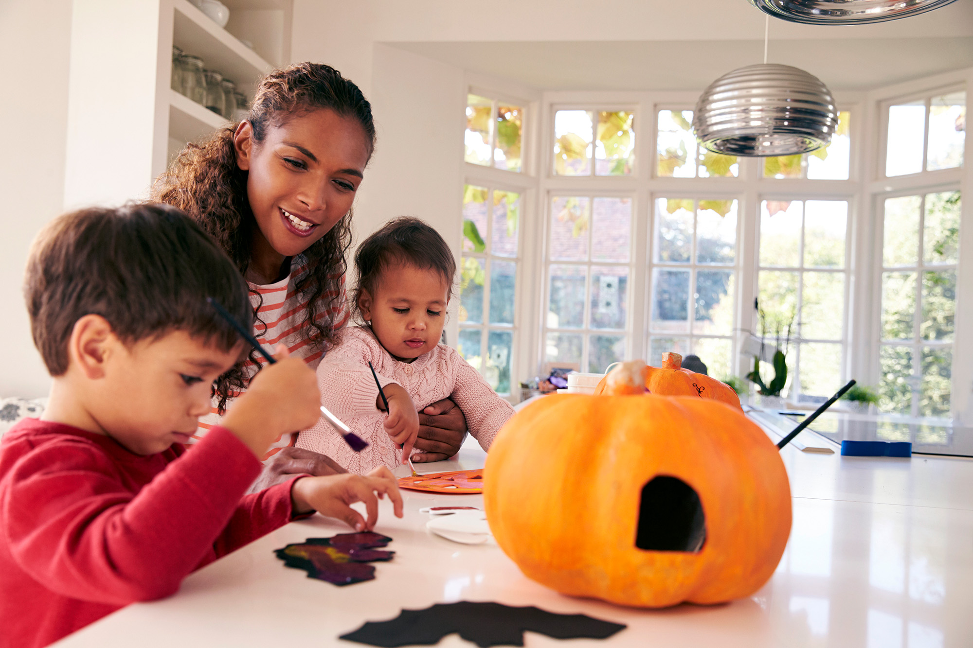 mother and children making Halloween decorations
