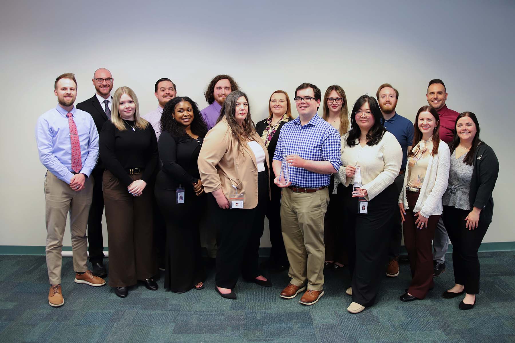 American Heritage Credit Union's Marketing team with two Diamond Awards