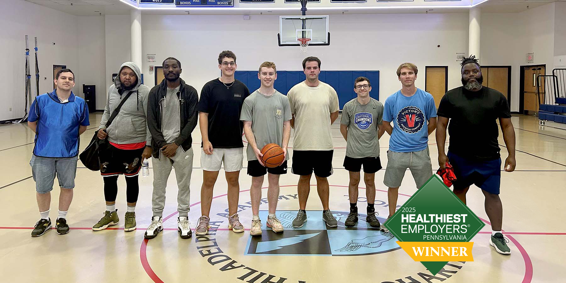 A group of American Heritage associates on a basketball court