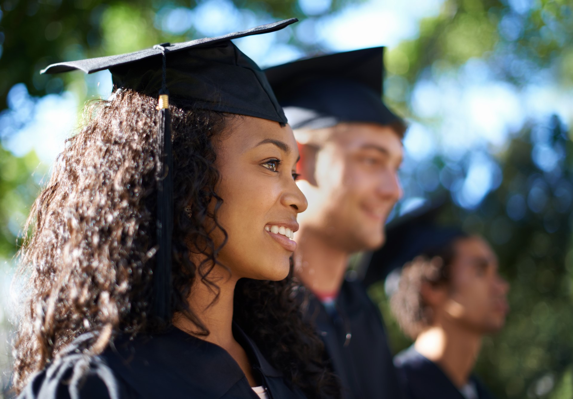 Three High School Graduates in their caps and gowns