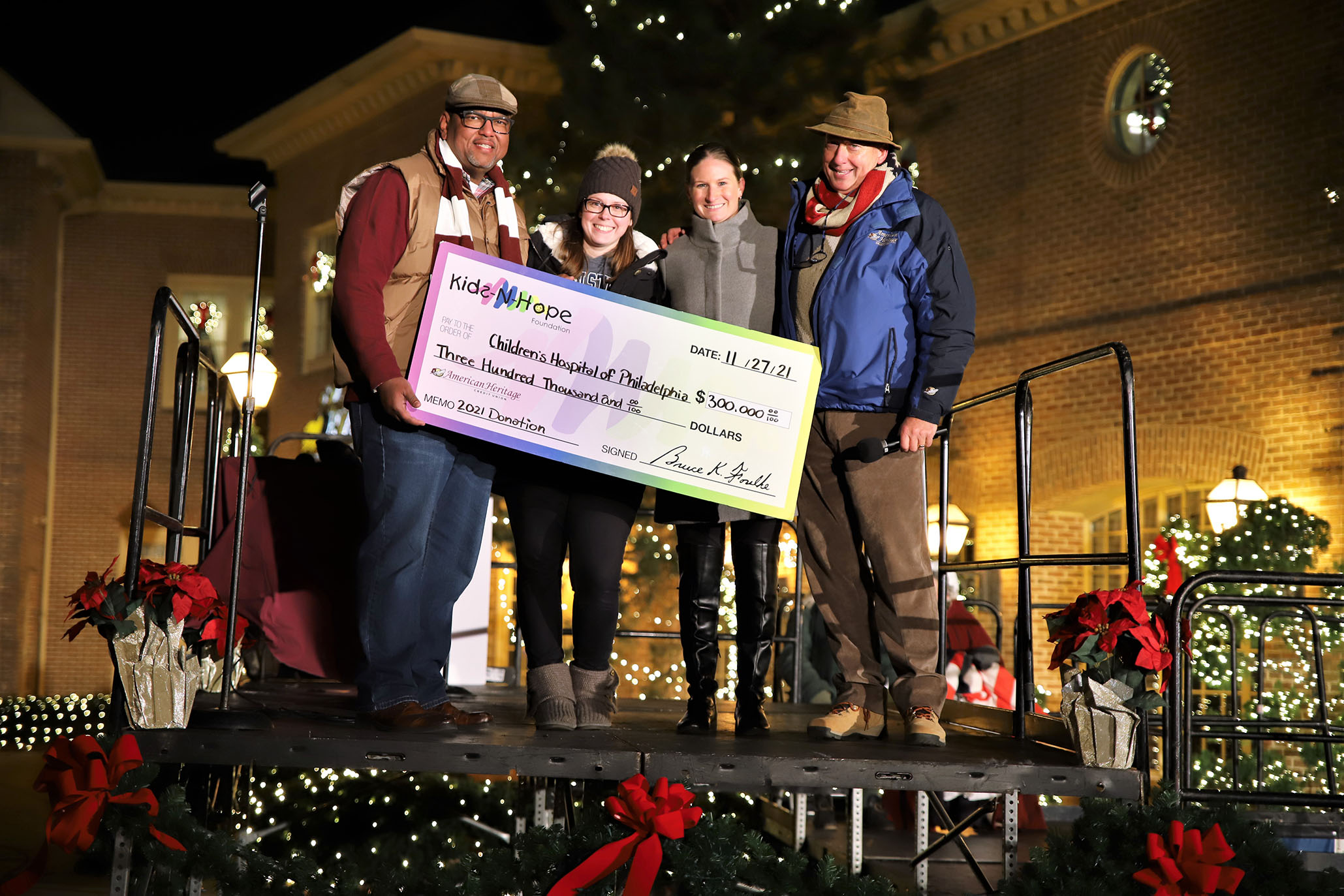 The Kids-N-Hope Foundation volunteers present Children’s Hospital of Philadelphia representative with check.