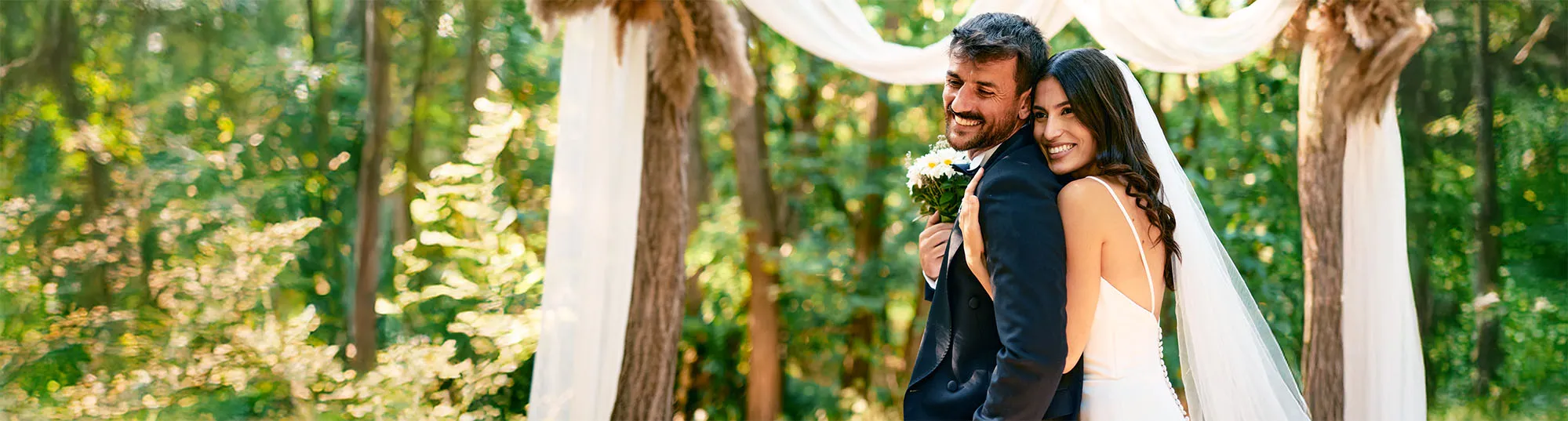 a newlywed couple on a white backdrop