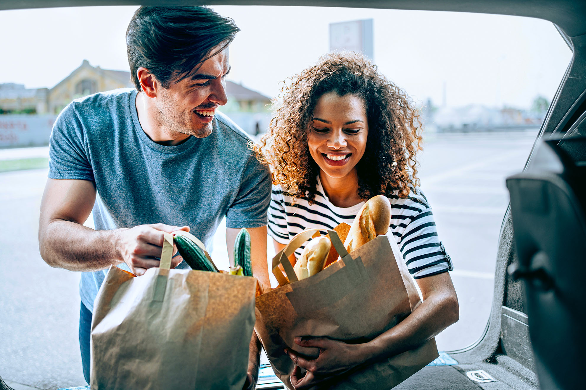 Partners putting groceries in the car